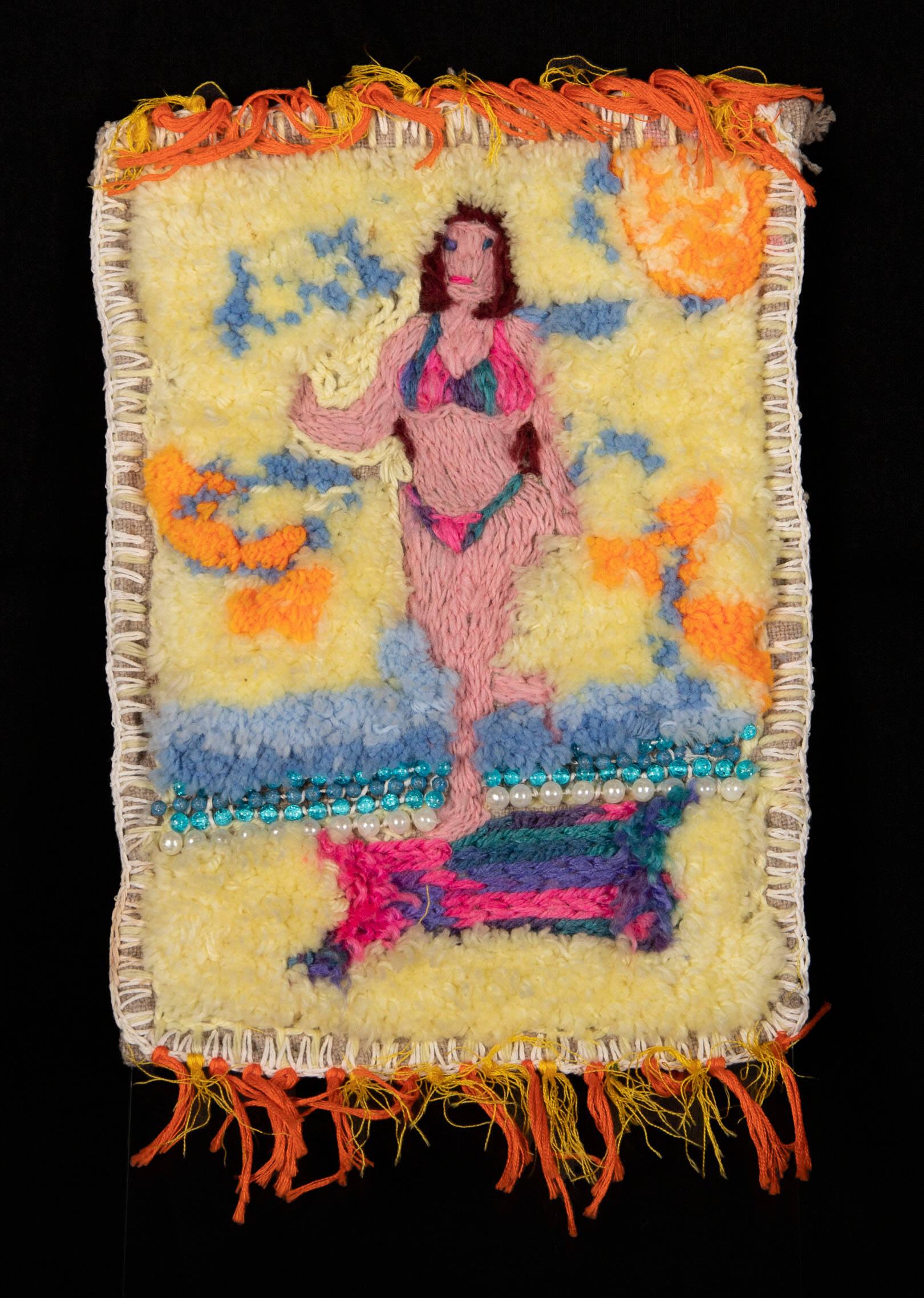 Woven textile rug with an image of a woman at the beach